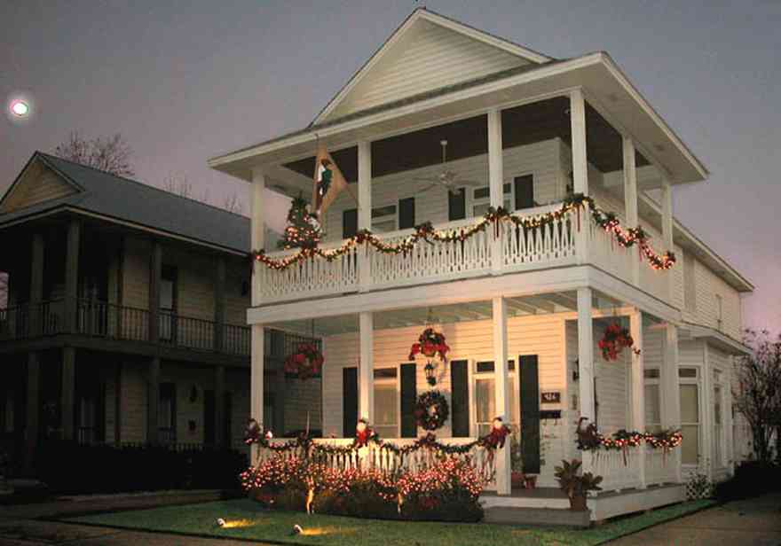 Pensacola:-Seville-Historic-District:-426-East-Intendencia-Street_01a.jpg:  garland, bows, poinsetta baskets, twinkling lights swags, shutters, front porch, victorian shotgun house, two-story house