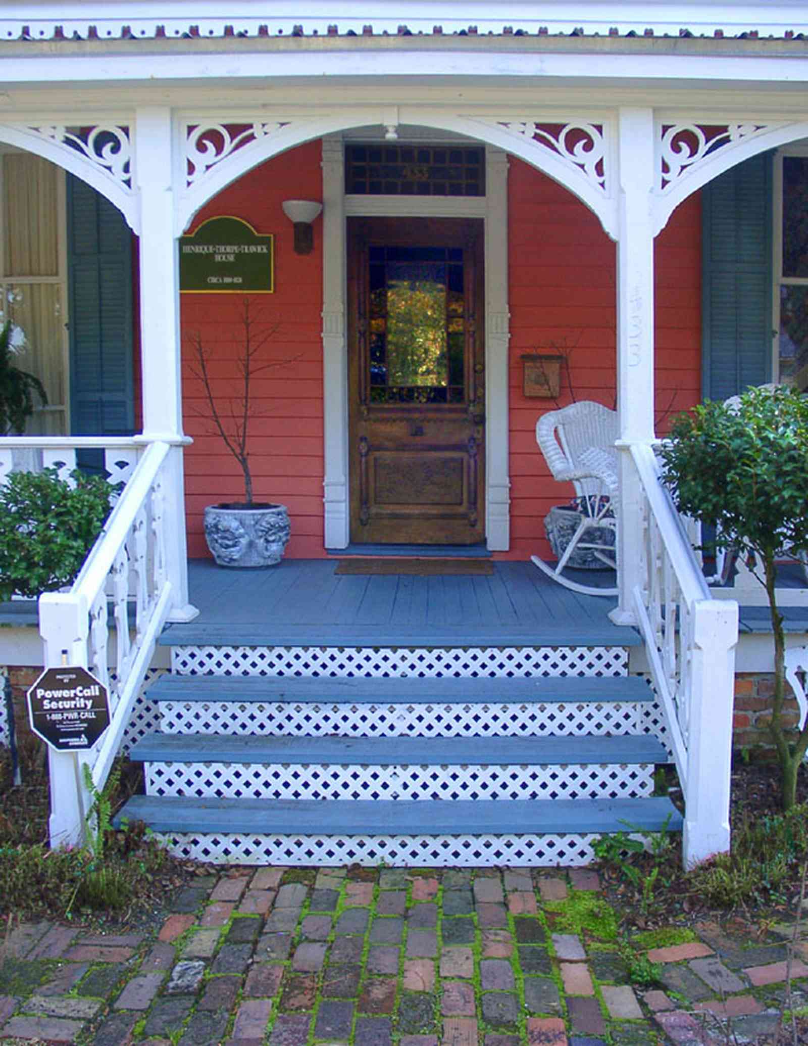 Pensacola:-Seville-Historic-District:-433-East-Zaragoza-Street_01.jpg:  victorian house, victorian front porch, wicker rocking chair, leaded stained glass, brick sidewalk