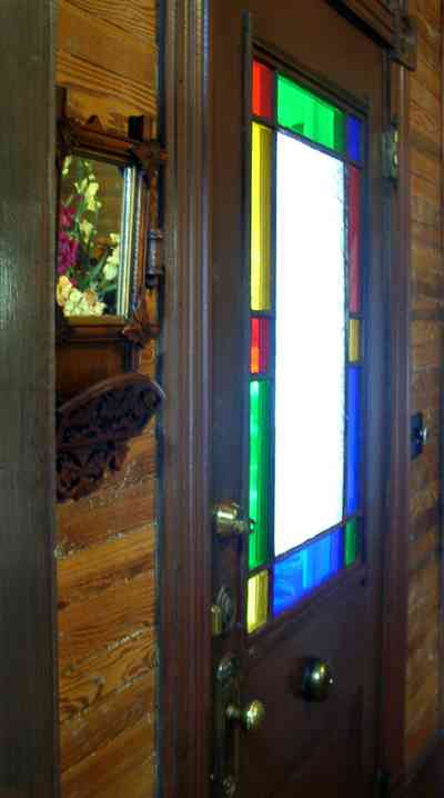 Pensacola:-Seville-Historic-District:-433-East-Zaragoza-Street_29.jpg:  stained glass door, victorian house, wooden walls, leaded and stained glass window