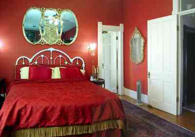 Pensacola:-Seville-Historic-District:-433-East-Zaragoza-Street_45.jpg:  victorian house, mirror, red bedroom, damask bedspread