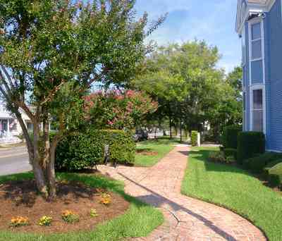 Pensacola:-Seville-Historic-District:-Kerrigan,-Estees,-Rankin,-McLeod-Law-Offices_03.jpg:  brick sidewalk, crepe myrtle trees, victorian home