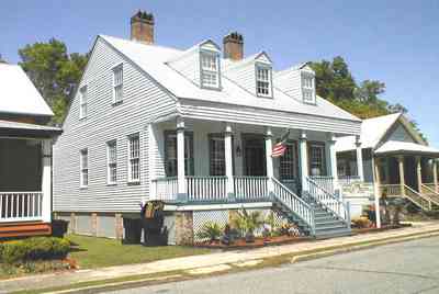 Pensacola:-Seville-Historic-District:-Michles-And-Booth-P.-A._00.jpg:  victorian house, four-square georgian home, american flag, intendencia street, dormer windows, raised cottage, old town, historic preservation