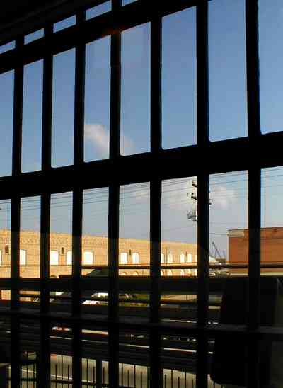 Pensacola:-Seville-Historic-District:-Old-City-Jail_13.jpg:  prisoner, jail, behind bars, barred windows, police department, city court, spanish revival building, pensacola museum of art