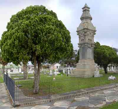 Pensacola:-Seville-Historic-District:-St-Michael-Cemetery_05.jpg:  wrought-iron fence, tiled sidewalks, cemetery, cedar trees
