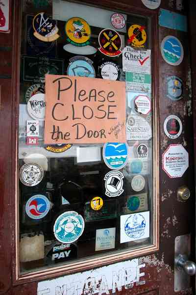 Perdido-Key:-Flora-Bama-Lounge_02b.jpg:  bar, lounge, door, wooden door, stickers, decals