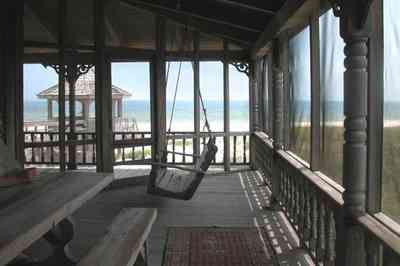 Perdido-Key:-Gothic-House_08c.jpg:  porch swing, porch, screen porch, summer house, gazebo, cedar shake roof, walkway, pier, deck, gulf of mexico, emerald water, dunes, sea oats, beach