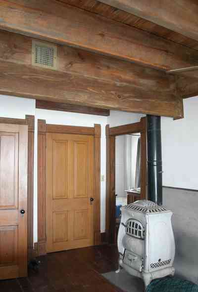 Perdido-Key:-Gothic-House_08p.jpg:  potbelly stove, heartpine lumber, bedroom, ceiling beams, marble facing