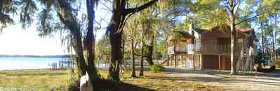 Peterson-Point:-Tree-House_02.jpg:  bay, house, spanish moss, pine tree, deck, boat house