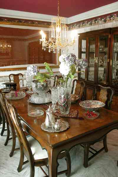 Scenic-Highway:-3780-Scenic-Ridge-Drive_06.jpg:  crystal chandelier, silver tea service, china cabinet, dried flowers, punch bowl, mirrored wall, marble floor